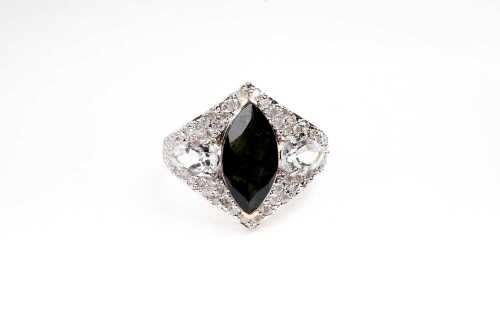 A green tourmaline, white topaz and diamond ring in 9 carat yellow gold