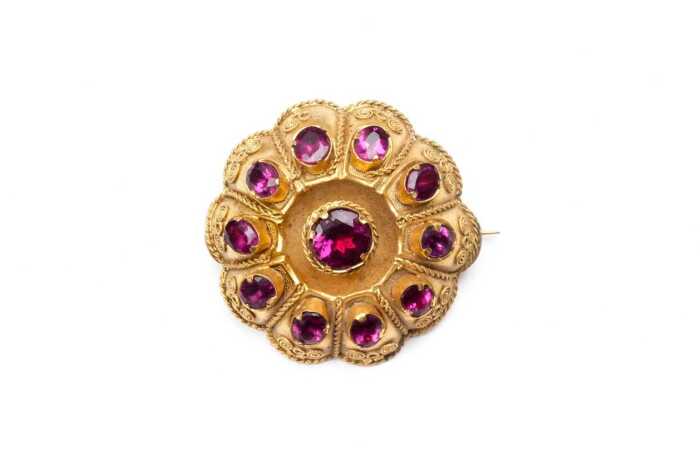 An antique garnet brooch in bloomed rolled gold