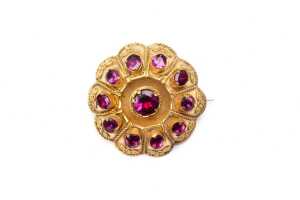 An antique garnet brooch in bloomed rolled gold
