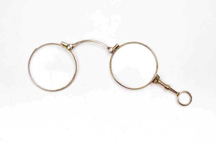 A pair of antique lorgnettes in 9 carat yellow gold