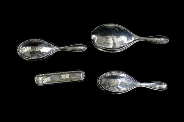English sterling silver mounted four piece dressing table set