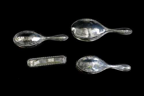 English sterling silver mounted four piece dressing table set