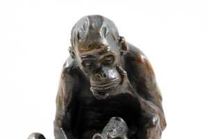 Bronzed figure of a monkey on books - 2