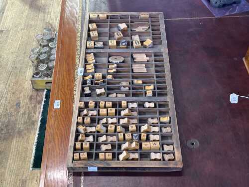 Vintage typesetters' tray with timber stamps