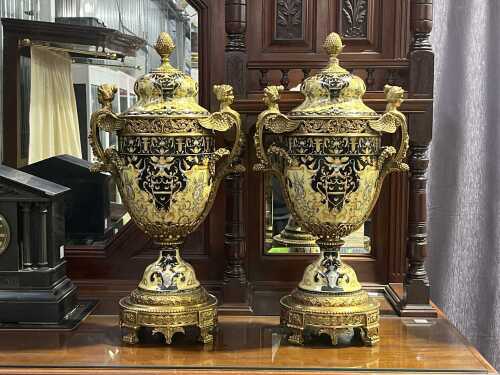 Pair of decorative Neo-Classical style ceramic urns with cast metal base and mounts