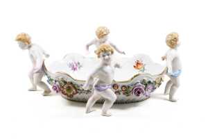Antique Von Schierholz porcelain centerpiece bowl, with applied floral details and four cherub figures