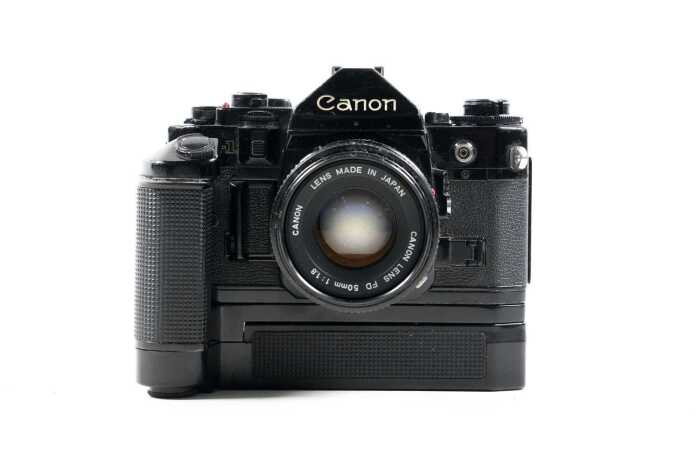 Canon A-1 SLR film camera with three lenses and accessories