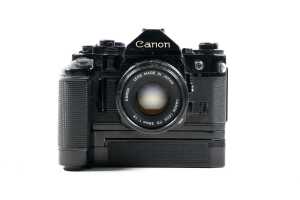 Canon A-1 SLR film camera with three lenses and accessories