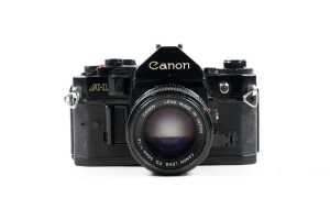Canon A-1 SLR film camera with two lenses and accessories
