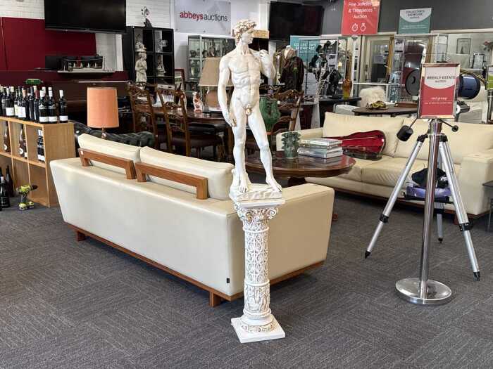 Plaster statue of Michelangelo's David with matching plinth