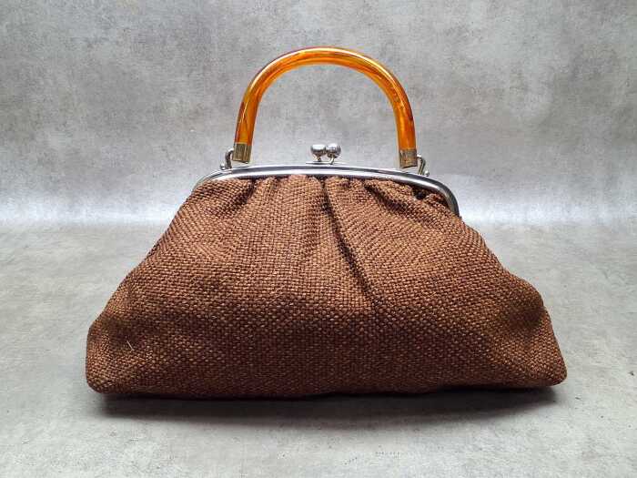 Brown woven fabric handbag with orange Lucite handle and kiss-lock