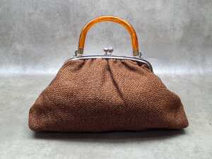 Brown woven fabric handbag with orange Lucite handle and kiss-lock