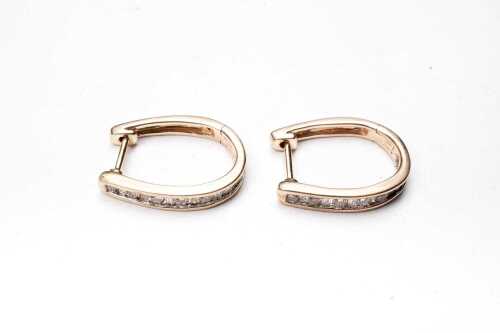 A pair of diamond hoops in 9 carat yellow gold