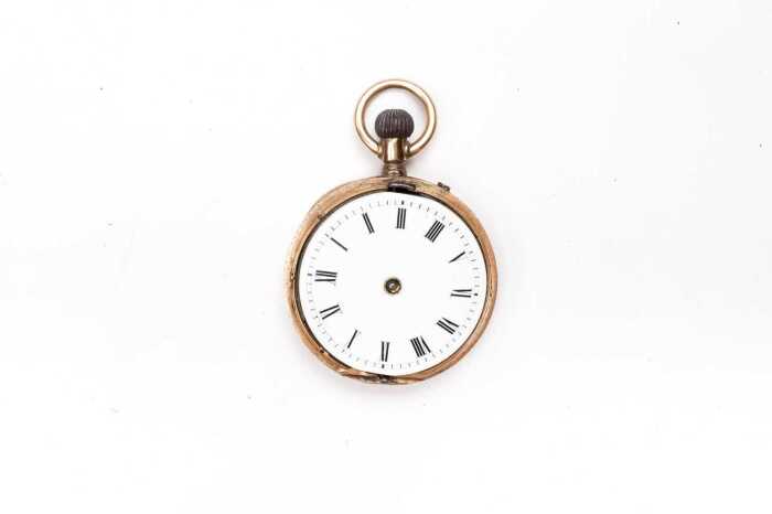 An antique pocket watch in 14 carat yellow gold