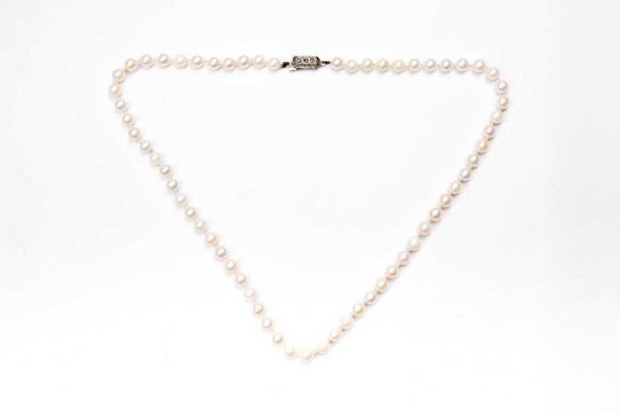A strand of pearls to a European silver clasp