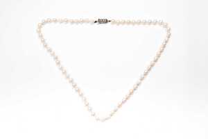 A strand of pearls to a European silver clasp