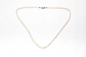 A strand of graduated pearls to a silver clasp