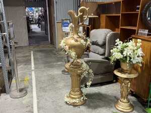 Gold tone urn on pedestal