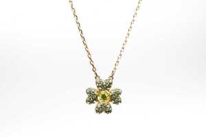 A Swarovski green Idyllia necklace in yellow gold tone