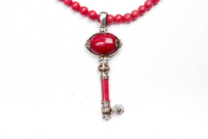 A red spinel bead and key necklace in sterling silver
