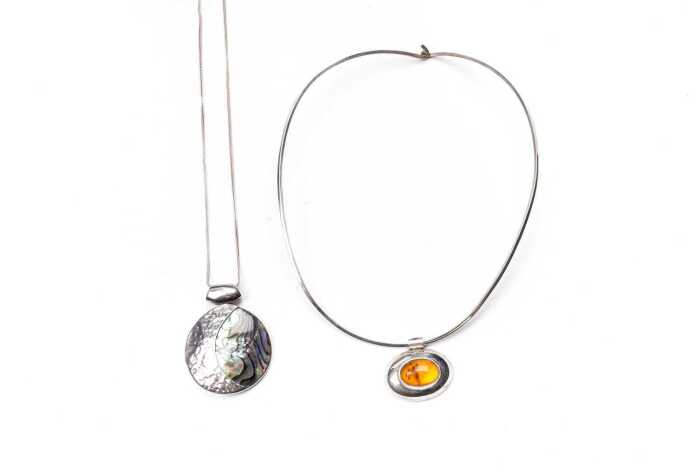 An amber collier and a paua shell necklace in sterling silver
