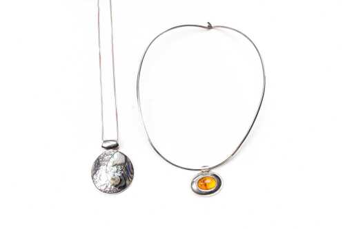 An amber collier and a paua shell necklace in sterling silver