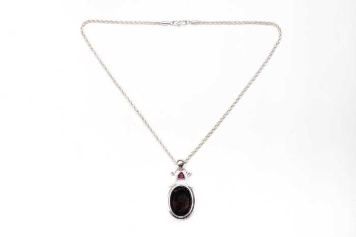 A garnet and smoky quartz pendant and necklace in sterling silver