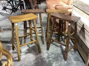 Four hardwood saddle style counter chairs