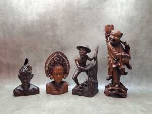 Four decorative hand-carved timber figures