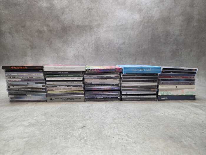 Assorted CDs, including Metallica and Queen