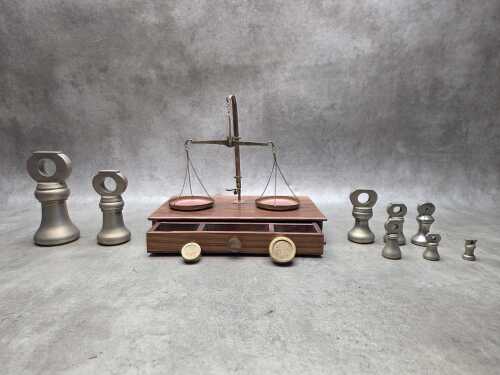 Vintage jeweller's scales on timber cabinet and assorted bell weights