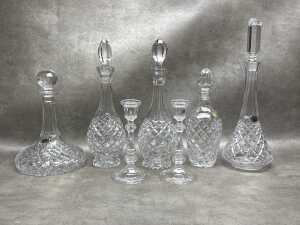 Cut crystal decanters and a pair of candlesticks