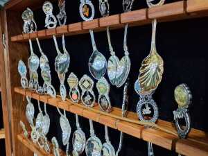 Collection of souvenir spoons in timber canteen - 2
