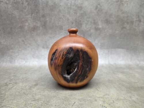 Hand-turned spherical Huon pine vase with natural knot detail