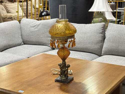 Vintage electrified kerosene lamp with amber glass and cherub base