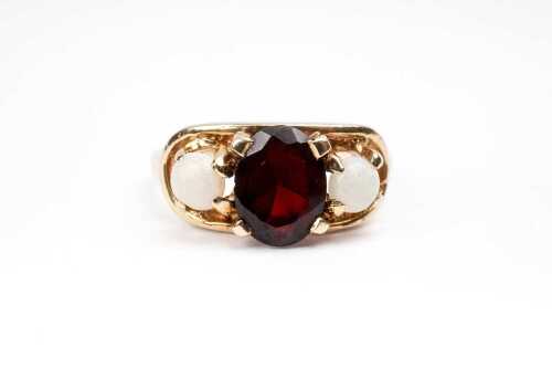 A vintage garnet and opal ring in 14 carat yellow gold