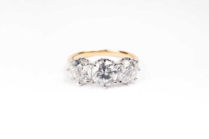 A diamond trilogy ring in 18 carat yellow and white gold