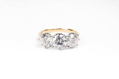 A diamond trilogy ring in 18 carat yellow and white gold