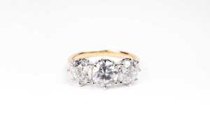 A diamond trilogy ring in 18 carat yellow and white gold
