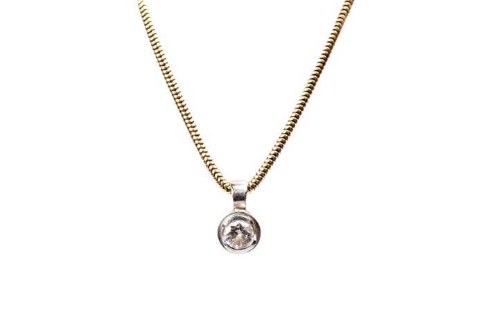 A diamond pendant and necklace in 18 carat yellow and white gold