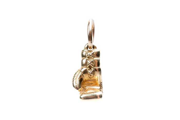 A solid boxing glove pendant in 9 carat yellow gold
