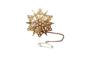 An antique seed pearl star brooch in 15 carat yellow gold