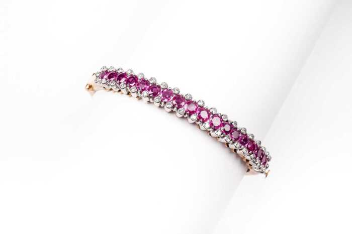 A ruby and diamond bangle in 14ct yellow and white gold