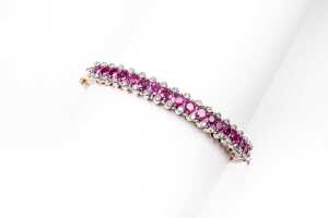 A ruby and diamond bangle in 14ct yellow and white gold