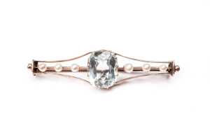 An antique aquamarine and pearl brooch in 9 carat yellow gold