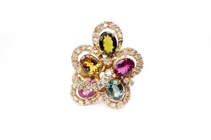 A diamond and multi gemstone ring in 14 carat yellow gold