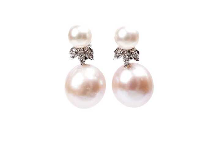 A pair of pearl and diamond earrings in 14 carat white gold