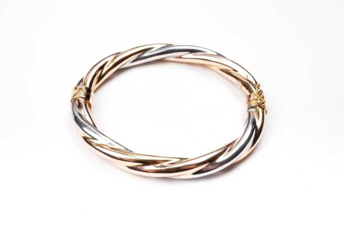 An Italian twist bangle in 9 carat yellow and white gold