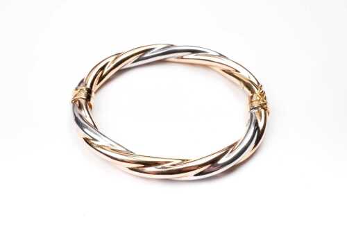 An Italian twist bangle in 9 carat yellow and white gold