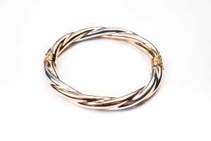 An Italian twist bangle in 9 carat yellow and white gold